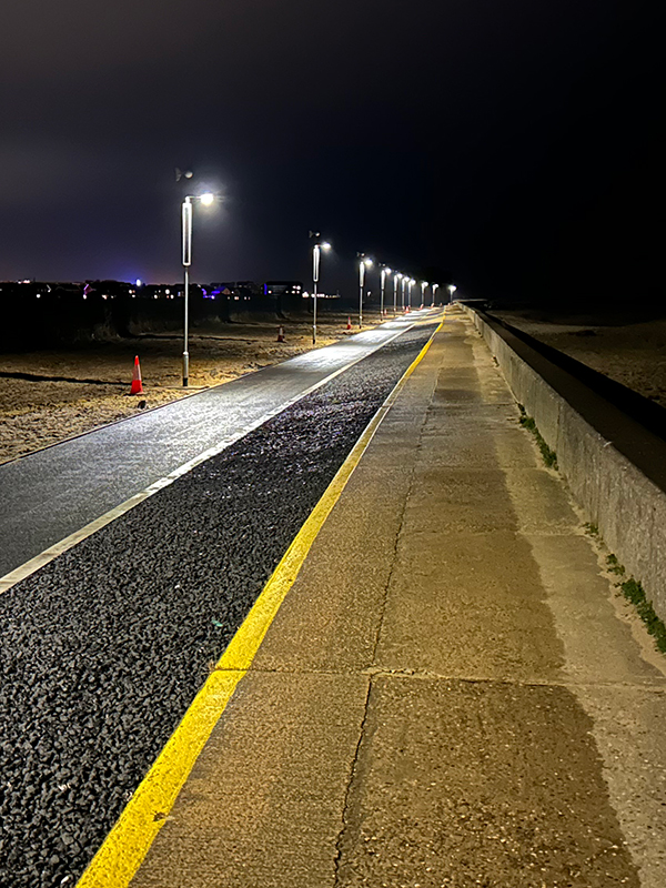 Cycle path at night lined with Kight off-grid street lights shining