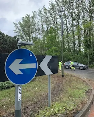 roundabout with arrow sign and lighting